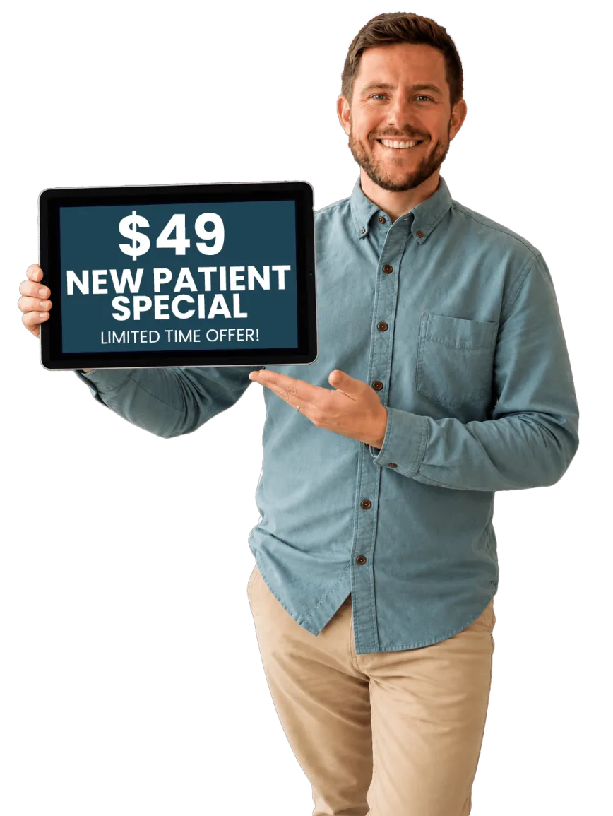 Dr. Evan Norum, DC, holding new patient special offer.