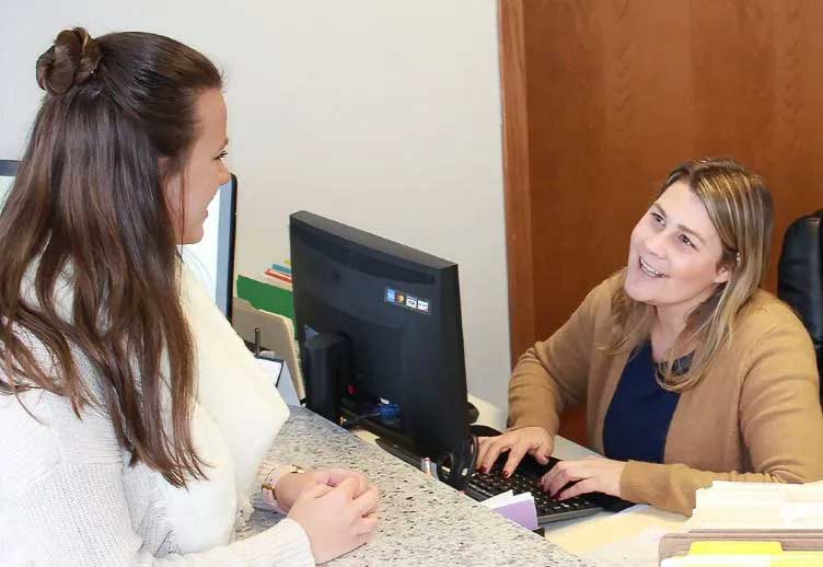 Receptionist at Advantage chiropractic in New Berlin answering patient questions.