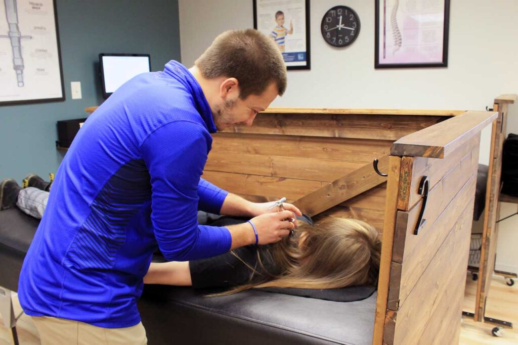 Chiropractor at Advantage Chiropractic adjusting patient with Torque Release Method