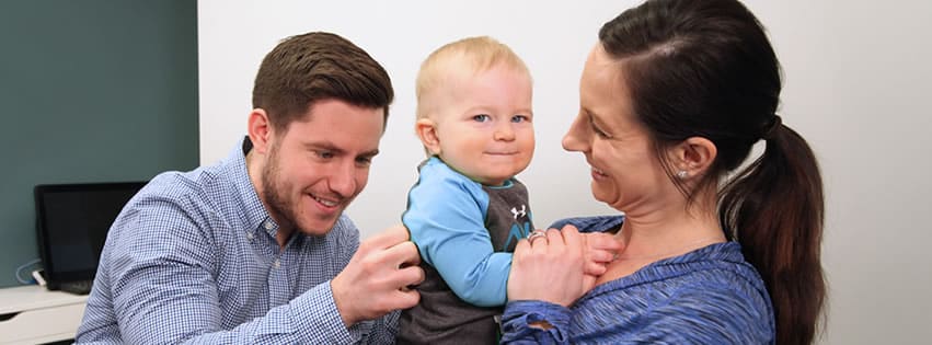 Infant getting examination by chiropractor.