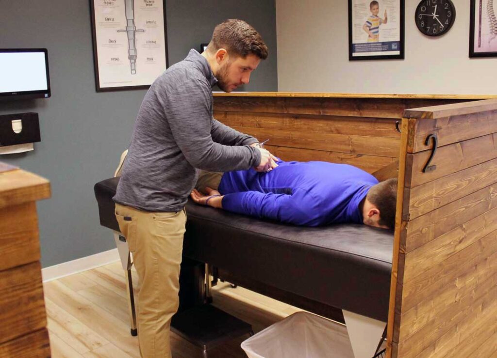 Chiropractor using the torque release technique with the Integrator on a patient.