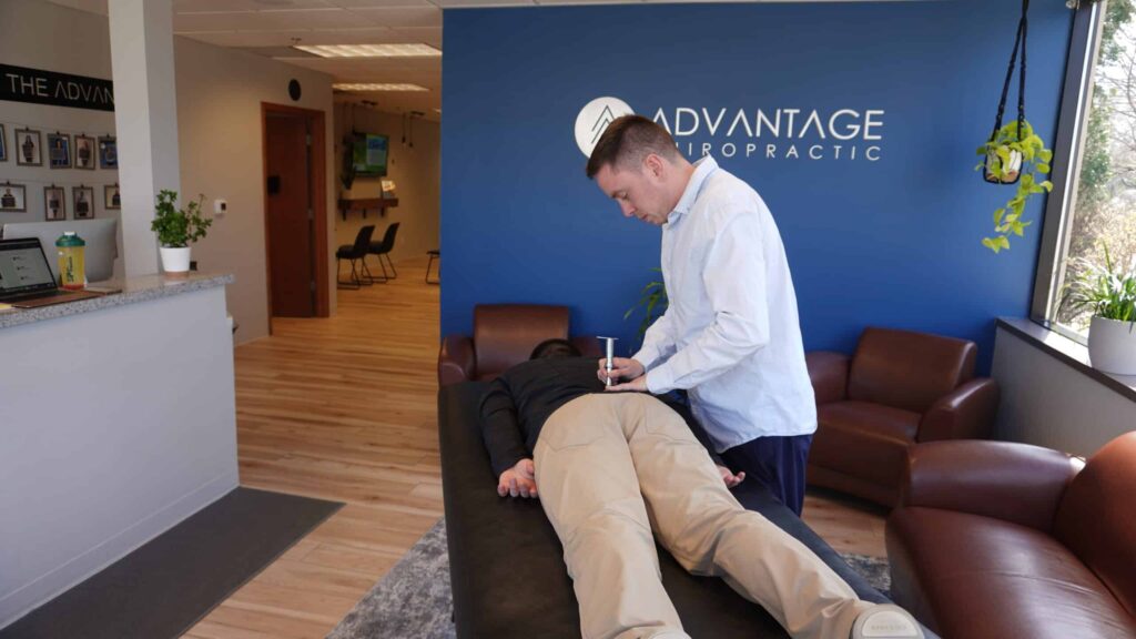 chiropractor adjusting patient with back pain related to car accident.