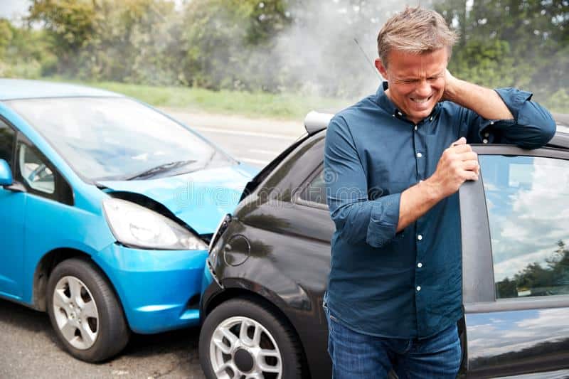 Man suffering from whiplash after a car accident.