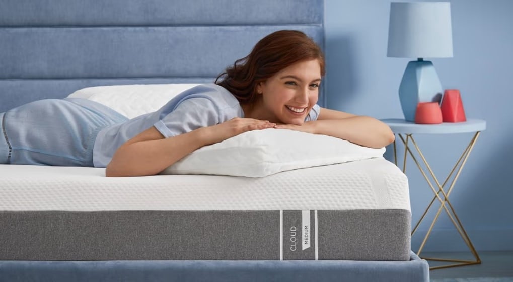 girl laying on tempur-pedic mattress and pillow.