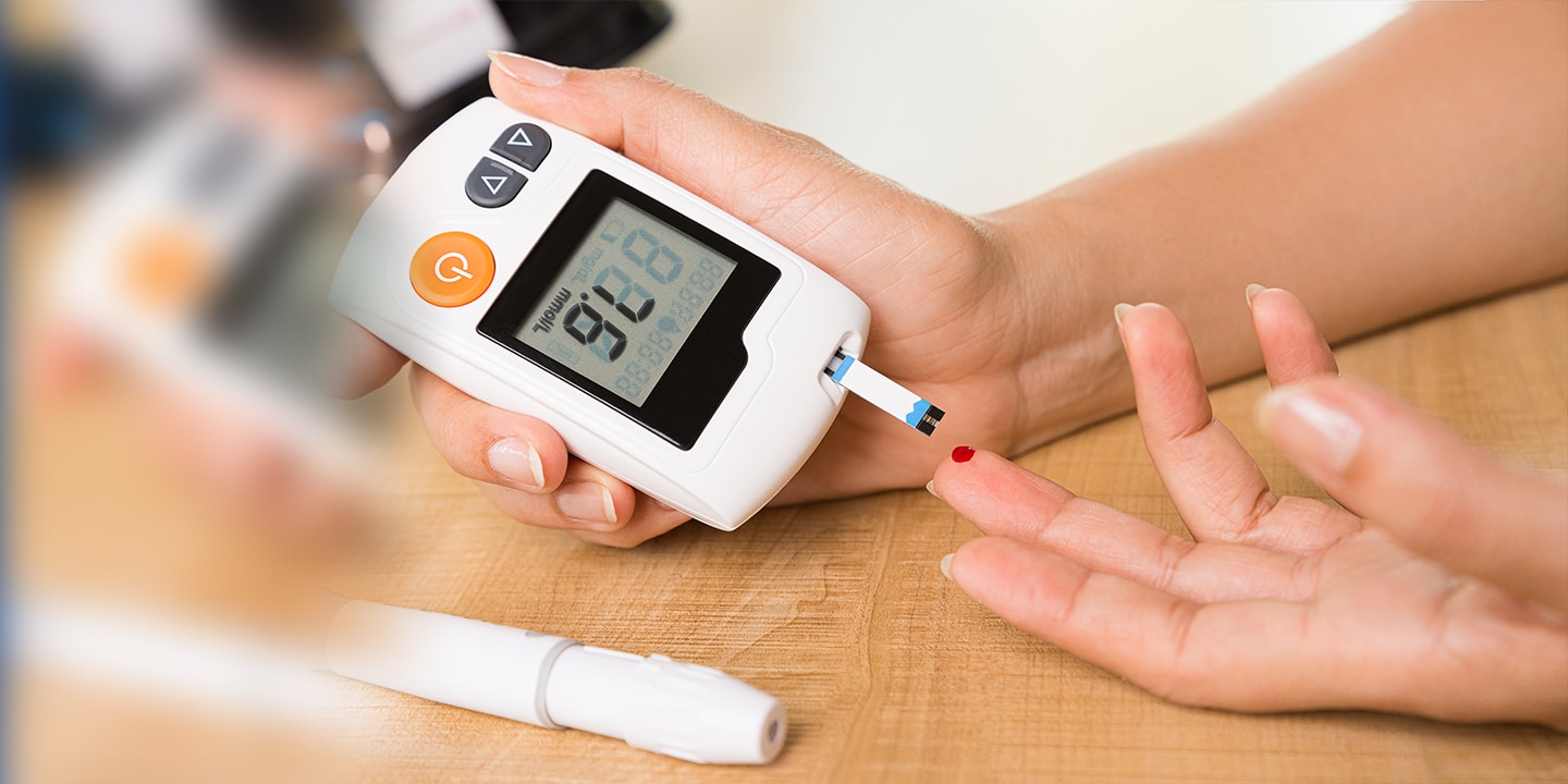 Woman testing blood sugar