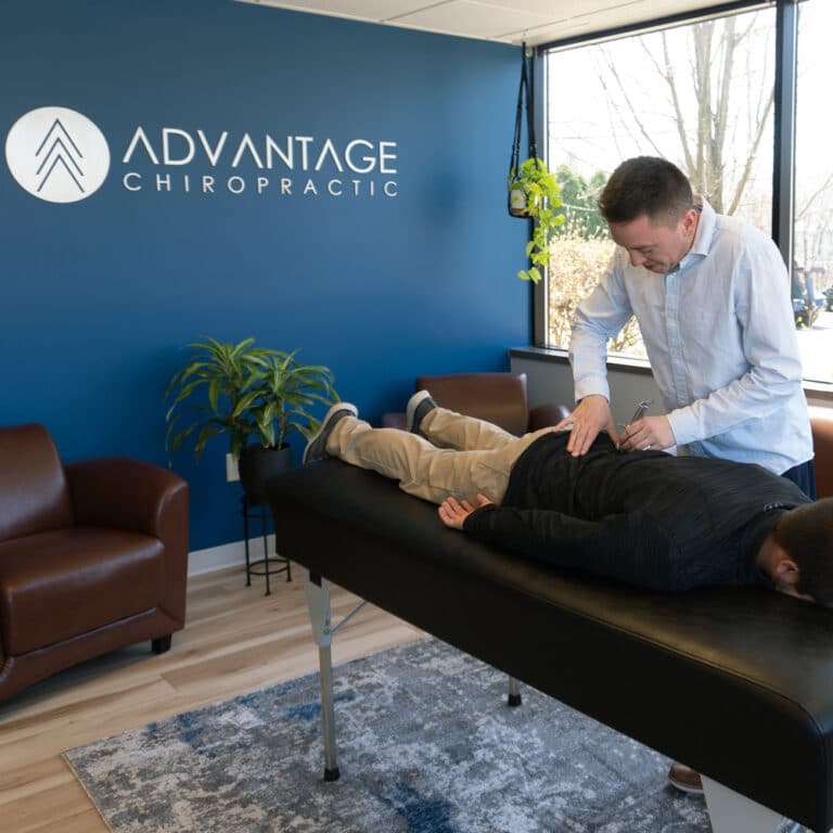 A chiropractor is examining a new patient in New Berlin.