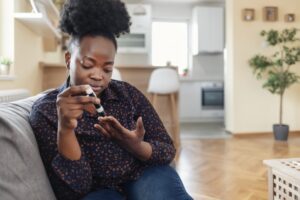 women poking her finger with a type of neuropathy
