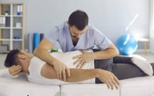 Chiropractor adjusting patient on a regular basis.