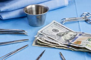 money laying on table with medical instruments