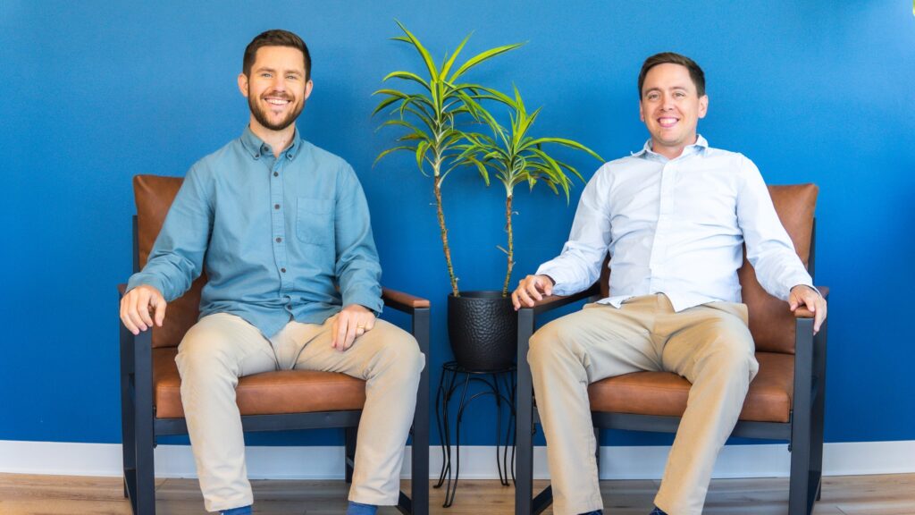 Neuropathy Treatment Doctors in Wauwatosa, WI sitting on two chairs.