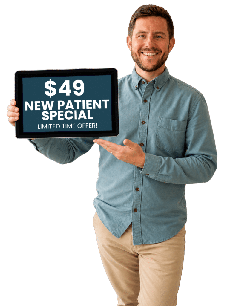 Dr. Evan Norum, DC, holding new patient special offer.